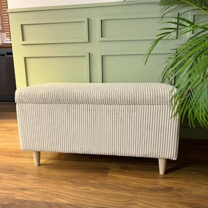 exclusive ivory corduroy bench with a storage unit and wooden legs for the entryway and a vintage style living room