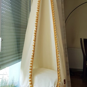 safe hanging chair for kids, hanging egg chair boho with pompoms, good hanging chair from handmade manufactures online, comfortable hanging egg chair in the living room