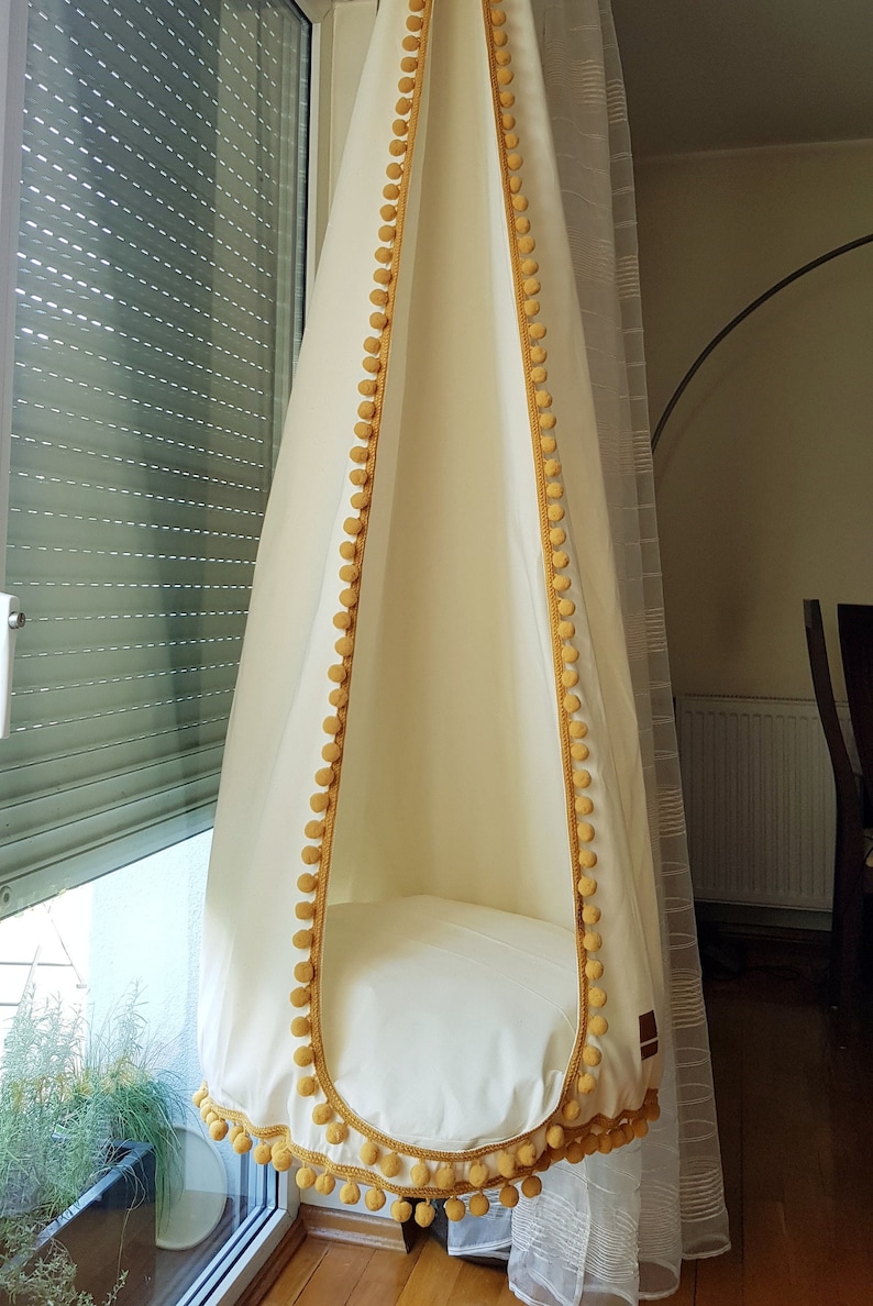 safe hanging chair for kids, hanging egg chair boho with pompoms, good hanging chair from handmade manufactures online, comfortable hanging egg chair in the living room
