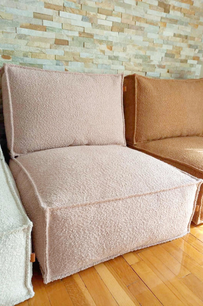 rose pink boucle floor cushion with a backrest pillow set in an arragement with caramel sofa