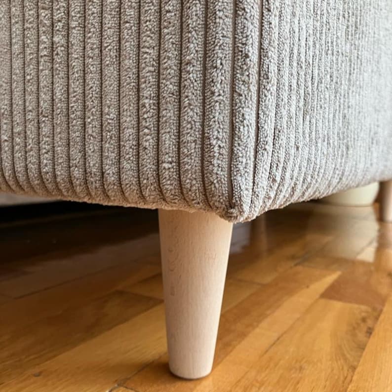vintage styled corduroy storage bench as a aesthetic pouf with wooden legs for the living room and a dining room as a housewarming gift idea for anniversary for parents