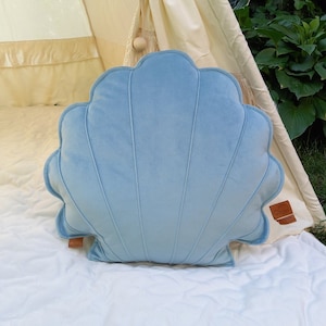 blue seashell pillow as a exclusive nautical cushion for a lady for her new beachy first home as a moving present gift idea