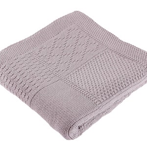 May include: A soft, light purple knitted throw blanket with a textured pattern.