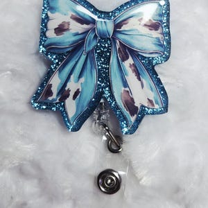 Blue with cow pring bow Badge Reel