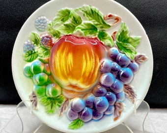 Vintage fruit themed wall plate featuring apples grapes and berries