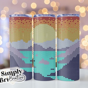 May include: Three stainless steel tumblers with a pixelated design of a sunset over mountains and a lake. The design features shades of orange, yellow, blue, green, and purple.