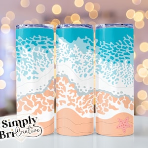 May include: Three stainless steel tumblers with a beach scene design. The design features blue and white waves, coral, and a pink starfish on a peach-colored sand background.