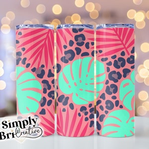 May include: Three stainless steel tumblers with a tropical print. The tumblers feature a pink background with green monstera leaves, pink palm leaves, and black leopard spots.