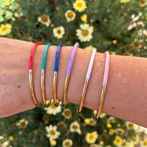 Round, two-tone bangle bracelet in gold and rose gold, white, purple, and blue. High quality, durable, and tarnish-resistant. A rare and original two-tone bangle.