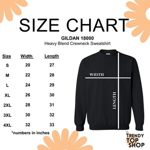 May include: Size chart for Gildan 18000 heavy blend crewneck sweatshirt. The chart shows the width and length in inches for sizes S through 4XL.