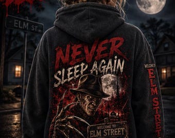 May include: A charcoal gray hooded sweatshirt featuring a graphic on the back with the text NEVER SLEEP AGAIN, a character wearing a fedora and a clawed glove, and a sign reading WELCOME TO ELM STREET WHERE YOUR NIGHTMARES COME TRUE.