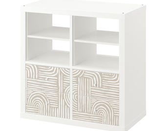 May include: White cube shelf unit with two drawers. The drawers have a beige and white geometric pattern.