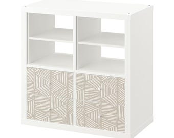 May include: White cube shelf unit with two drawers. The drawers have a beige geometric pattern.