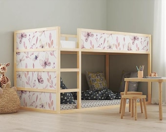 May include: A wooden bunk bed with a floral patterned headboard and a white mattress. The bed is decorated with pillows and a blanket. There is a small table and two stools next to the bed.