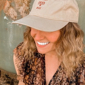 Pro Roe Reproductive Rights Dad Hat in a beige color. Representing Abortion rights, as well as women's rights to control their own body. Pro choice hat depicts embroidered uterus, reading "Pro Roe."