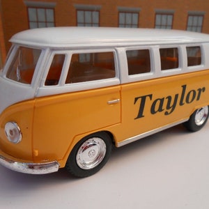 May include: Yellow and white toy Volkswagen bus with the name "Taylor" printed on the side.