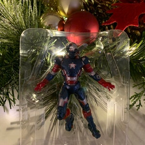 May include: A red, white and blue action figure of Iron Man in a clear plastic display case. The figure is in a flying pose with arms outstretched.