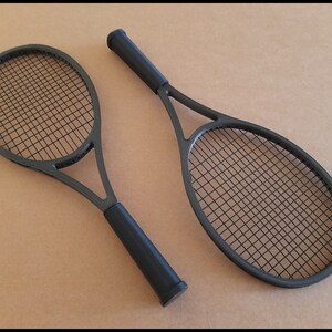 May include: A set of three ceramic mugs with a speckled, cream-colored glaze. Each mug features a different hand-painted floral design in shades of blue, green, and yellow. The mugs have a simple, rounded shape and a comfortable handle.