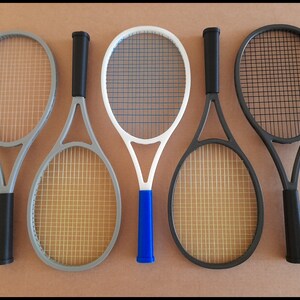 May include: A set of three ceramic mugs with a speckled, matte finish. The mugs are in shades of cream, light gray, and dark gray. Each mug has a simple, minimalist design and a rounded handle.