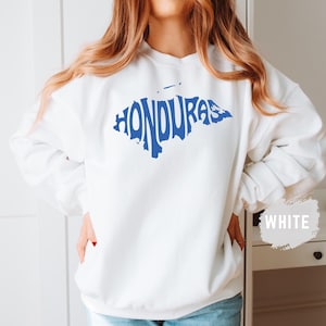 May include: White sweatshirt with a blue outline of Honduras in the shape of the country. The word "Honduras" is spelled out within the outline.