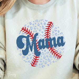 May include: A light beige sweatshirt with a blue and red baseball design. The baseball has a white and light blue leopard print pattern and the word "Mama" written in blue.