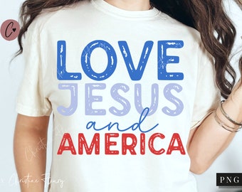 May include: White t-shirt with the text "LOVE JESUS and AMERICA" in blue, purple, and red lettering. The letters have a distressed, hand-drawn look.