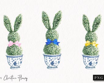 Puede incluir: Tres plantas de conejito topiario en macetas de cerámica azul y blanca con lazos rosa, azul y amarillo.