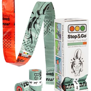 May include: A white cardboard box labeled Stop & Go Stoplight Poop Bags with a cartoon squirrel, containing light green waste bags. A long strip of light green bags with black squirrel graphics and an orange bag at the end are displayed alongside two rolls.