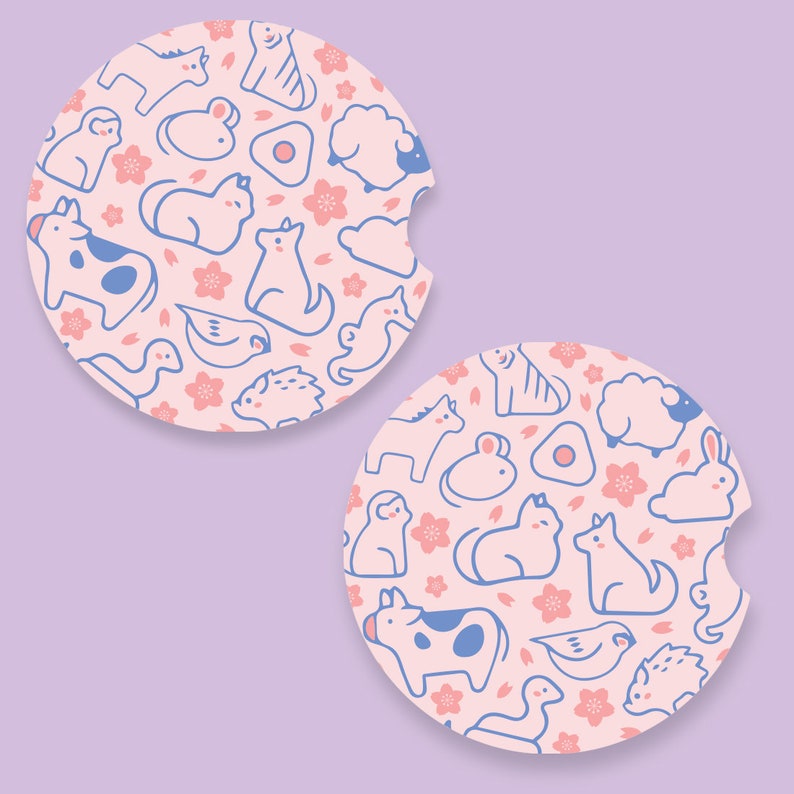 May include: Two pink and blue round coasters with a repeating pattern of animals, flowers, and eggs. The animals include a cow, cat, dog, sheep, bird, mouse, and hedgehog.