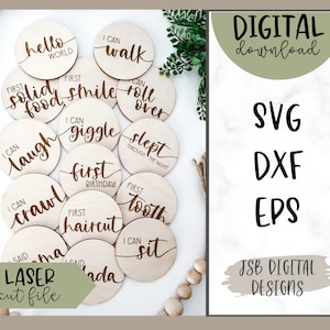 May include: A collection of wooden milestone discs, each inscribed with phrases such as "Hello World" and "I Can Walk." The image also features text stating "DIGITAL download" and "SVG, DXF, EPS." The words "LASER cut file" are also visible.