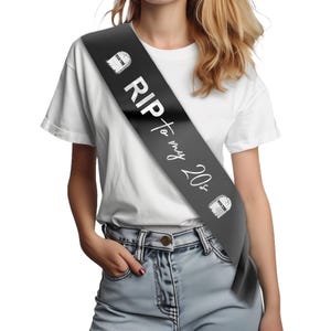 May include: Black satin sash with white text that reads "RIP to my 20s".  Two white tombstone graphics with the word "Youth" on them are on either end of the sash.