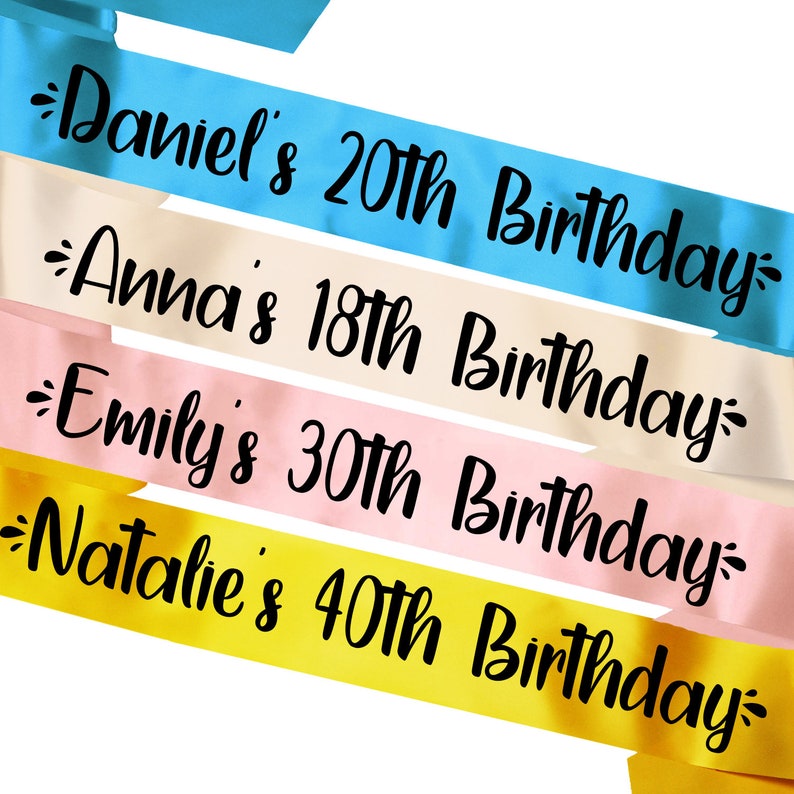 May include: Four colorful satin ribbons with black text. The ribbons read "Daniel's 20th Birthday", "Anna's 18th Birthday", "Emily's 30th Birthday", and "Natalie's 40th Birthday".