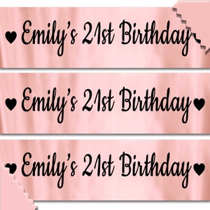 May include: Three pink satin sashes with black hearts and the text "Emily's 21st Birthday" printed on each sash.