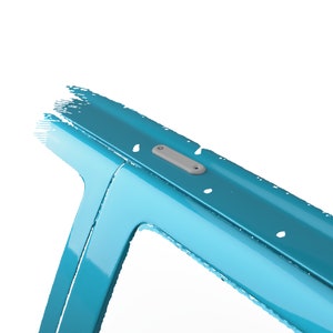 May include: A close-up of a blue metal surface with a gray plastic tag attached to it. The tag has a small hole in the center.