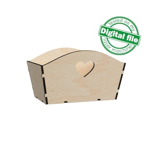 May include: A wooden box with a heart-shaped cutout. The box is light brown and has a smooth finish. It is a decorative box that can be used for storage or display.