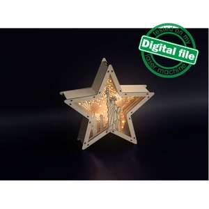 May include: A wooden star-shaped light-up box with a cutout design of the Statue of Liberty and the New York City skyline. The box is lit from within, creating a warm glow.
