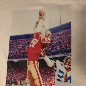 49ers “The Catch” Premium T shirt in Mens sizes S-3XL in White or Black! Printed on Kirkland brand T-Shirts!