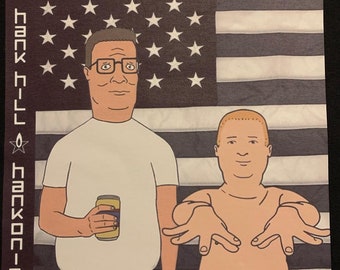 Hank Hill & Bobby “Hankonia” Premium T-Shirt in Mens sizes S-3XL in black or white! Heat Pressed on Kirkland brand T-Shirts!