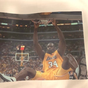 Shaquille O’Neal Lakers Poster Dunk Premium T Shirt in Men’s sizes S-3XL in White or Black! Printed on Kirkland brand T-Shirts!