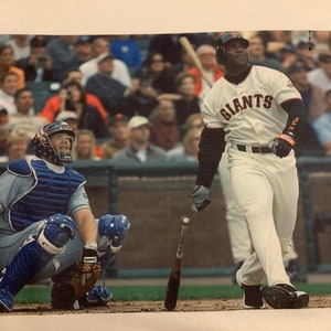 Barry Bonds admiring a Home Run premium T-Shirt in Mens sizes S-3XL in black or white! Printed on Kirkland brand T-Shirts!