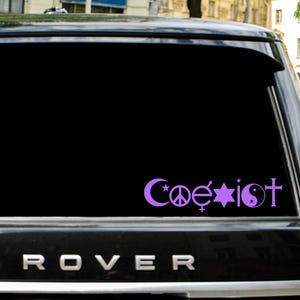 May include: A purple "Coexist" sticker on a car window. The design includes symbols for different religions and peace. The word "Coexist" is written in a stylized font.