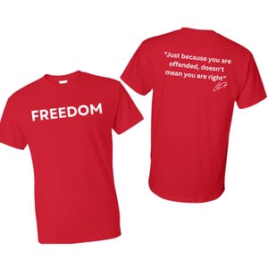 May include: Two red t-shirts. One shirt displays the word "FREEDOM" in white block letters. The other shirt has the quote, "Just because you are offended, doesn't mean you are right" in white text.