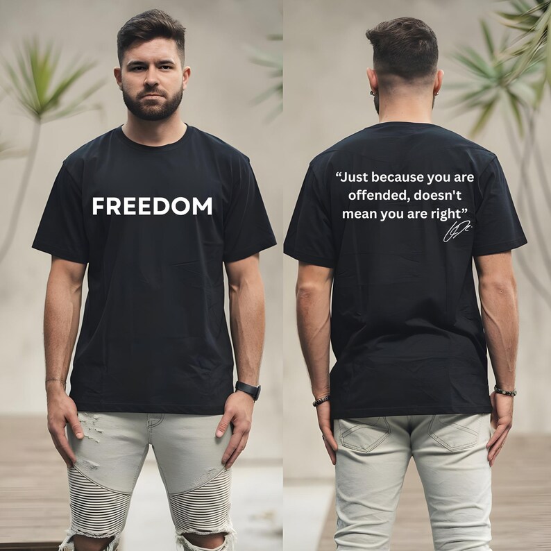 May include: Black t-shirt with the word "FREEDOM" in white block letters on the front. The back of the shirt has the quote, "Just because you are offended, doesn't mean you are right" in white.
