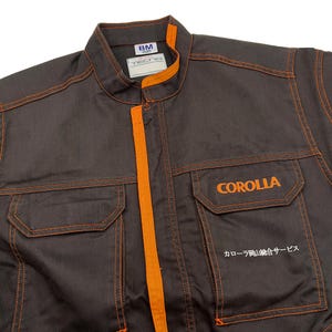 Very rare straight from Japan JDM TOYOTA トヨタ Corporate Tecno mechanic jumpsuit - coverall suite; A true gem for automotive enthusiasts seeking a unique piece of automotive history. This tsunagi is unavailable in the States, making it a rare find that sets you apart from the crowd.