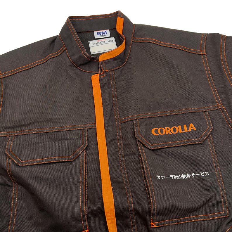 Very rare straight from Japan JDM TOYOTA トヨタ Corporate Tecno mechanic jumpsuit - coverall suite; A true gem for automotive enthusiasts seeking a unique piece of automotive history. This tsunagi is unavailable in the States, making it a rare find that sets you apart from the crowd.