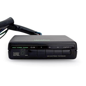 May include: Black HKS Turbo Timer with a digital display and buttons labeled 0.5, 1, 3, 5, and OFF. The timer also has a random access control feature.