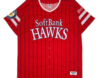 May include: Red and white baseball jersey with blue stripes and the words "SoftBank HAWKS" in white on the front. The jersey has a white Coca-Cola logo on the right sleeve and a white patch with a bird logo and the words "HAWKS" on the left sleeve. The jersey has a white tag with the text "鷹の祭典 2021" on the bottom right.