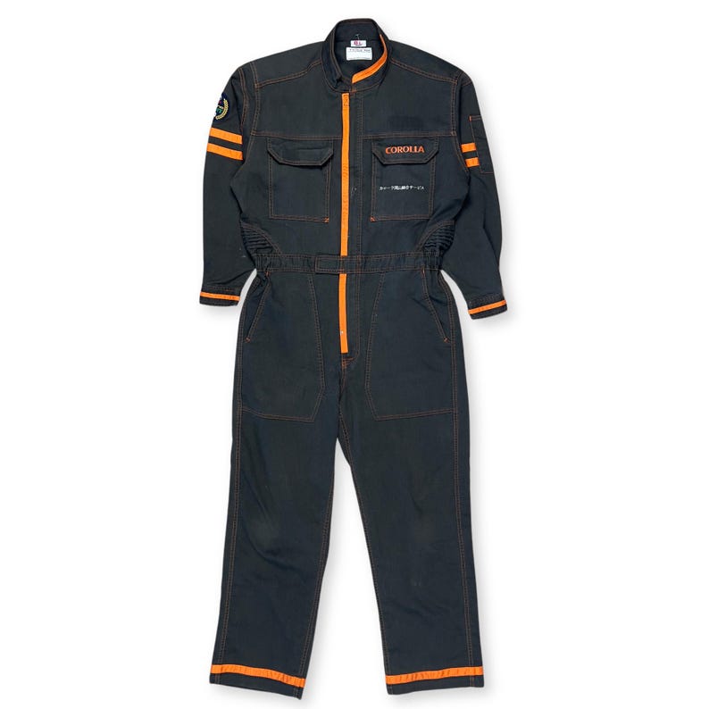 Very rare straight from Japan JDM TOYOTA トヨタ Corporate Tecno mechanic jumpsuit - coverall suite; A true gem for automotive enthusiasts seeking a unique piece of automotive history. This tsunagi is unavailable in the States, making it a rare find that sets you apart from the crowd.