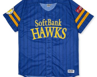 May include: A blue baseball jersey with white pinstripes and yellow and black trim. The jersey has the words "SoftBank HAWKS" in yellow lettering on the front. The jersey also has a small patch on the left sleeve with the words "HAWKS" in yellow lettering on a blue background. The jersey has a Coca-Cola patch on the right sleeve.