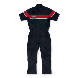 May include: Black short-sleeved jumpsuit with a red and white stripe across the chest. The jumpsuit has the word "NISSAN" printed in white on the chest.